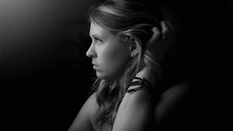 Healing came as I began to process the fear and events of my past. As I worked to express my true emotions of past and present, I experienced healing because I was regaining my voice and using it to respond to past triggers. A woman looking away from the camera.
