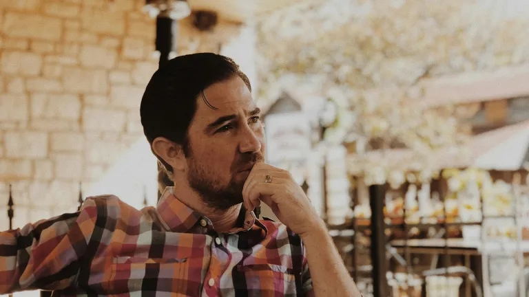 Jesus established His Church not as a large institution, but as a faithful “little flock” commissioned to preach the gospel, prepare a people, and shine as lights in a darkened world—could He be calling you to be part of it today? A man in deep thought while sitting outside.