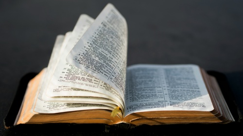 an open Bible with pages turning