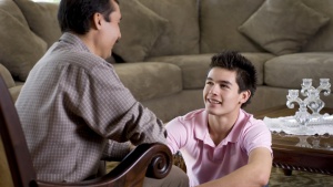 A dad and son talking.