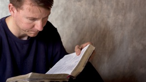 A man reading a Bible.