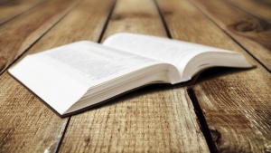 An open Bible laying on a table.