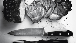 Sliced meat on chopping board