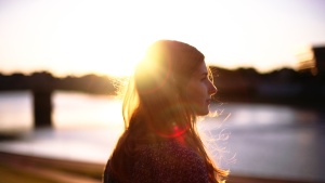 A woman with the sun reflecting through her hair.