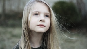 A young girl looking up.