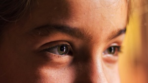 Upclose photo of young woman's face.