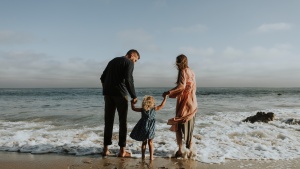 A family wading in the waves of the ocean.