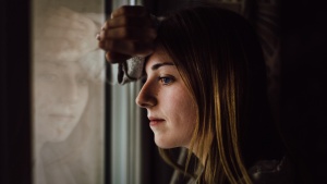 A woman looking out a window.