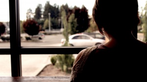 A woman staring out a window. 