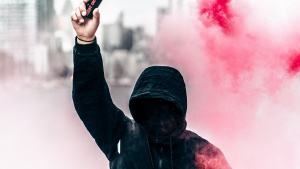 Protester with can of smoke