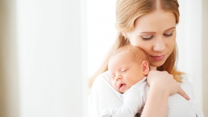 A woman holding a baby.