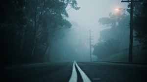 a road a twilight leading into the fog