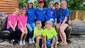 a group of campers and staff wearing camp shirts outdoors