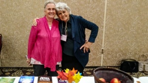 two ladies standing at the information table