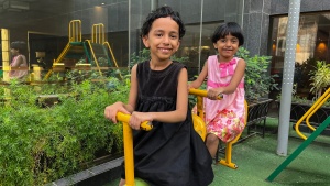 two children enjoying playground equipment