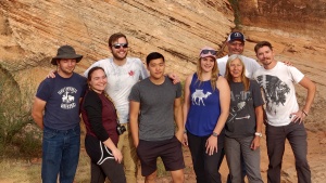 a group of people outdoors with rocks in the background