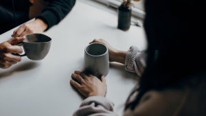 Two people talking over coffee