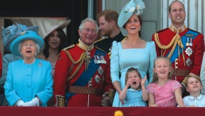 Four generations of Britain’s royal family watch a military flyover at Buckingham Palace.