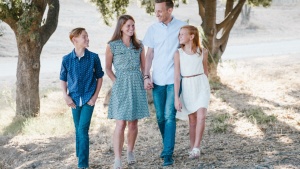 A family walking in the woods.