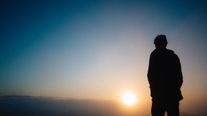 A person looking at a sunset.