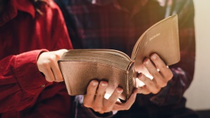 Two people looking at an open Bible.