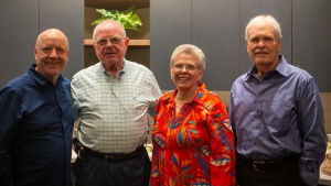 four people standing indoors