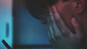 A young person looking at their phone.