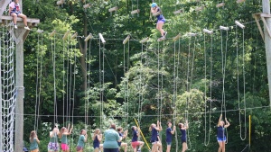 campers using a high ropes course outside