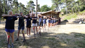 a group of teenage girls with bows and arrows