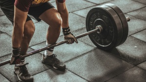 a man squatting to pick up a heavy weight