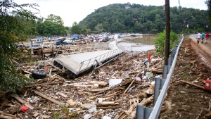 The Rocky Broad River flows into Lake Lure and overflows the town with debris from Chimney Rock, North Carolina after heavy rains from Hurricane Helene on Sept. 28, 2024.