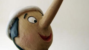 Wood carving of Pinocchio with a long nose.