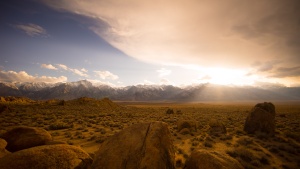 A high plains desert with snow capped mountains in the distance.