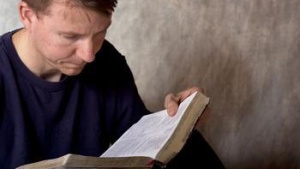 A man reading a Bible.