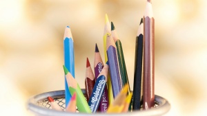 colored pencils in a metal basket