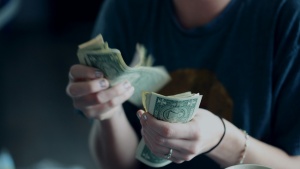 A man holding a handful of cash.