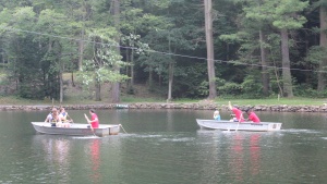 Campers in row boats on the river. 