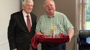 Dr. Ward presents Mr. Seelig with a gift in honor of his service as corporate secretary.