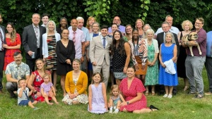 a large group of people seated and standing outside