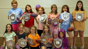 A group of girls holding up homemade shields
