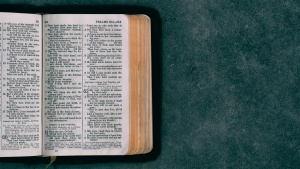 an open Bible on a blue background