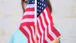 A girl holding an America Flag