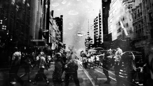 Crowds of people walking a street.