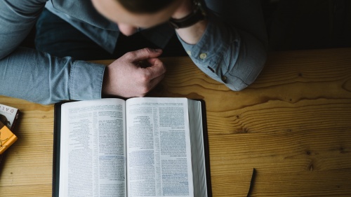 A man reading a Bible.