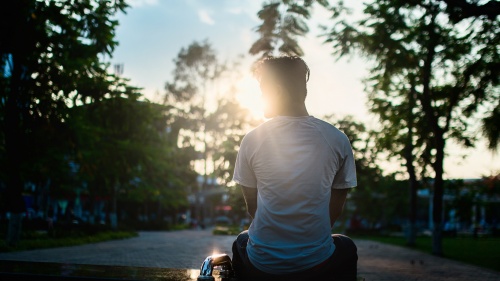 A teenage boy sitting by himself.