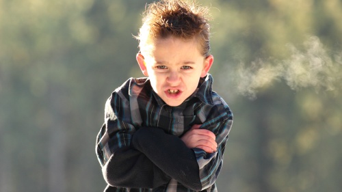 A young boy looking angry.