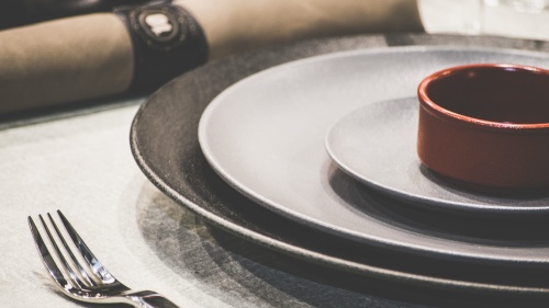 A table set with plates for a dinner.