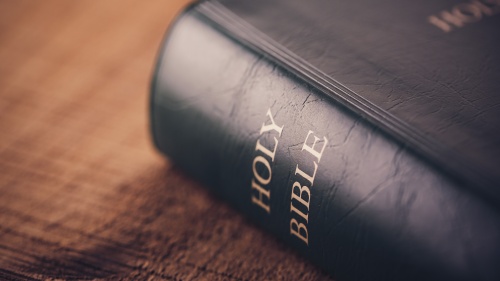 Bible laying on top of a table