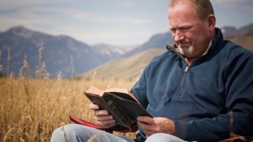 A man reading a Bible.