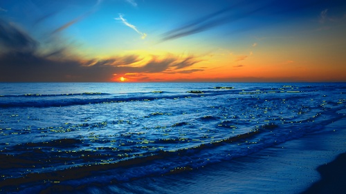 Blue and orange sunrise over an ocean.